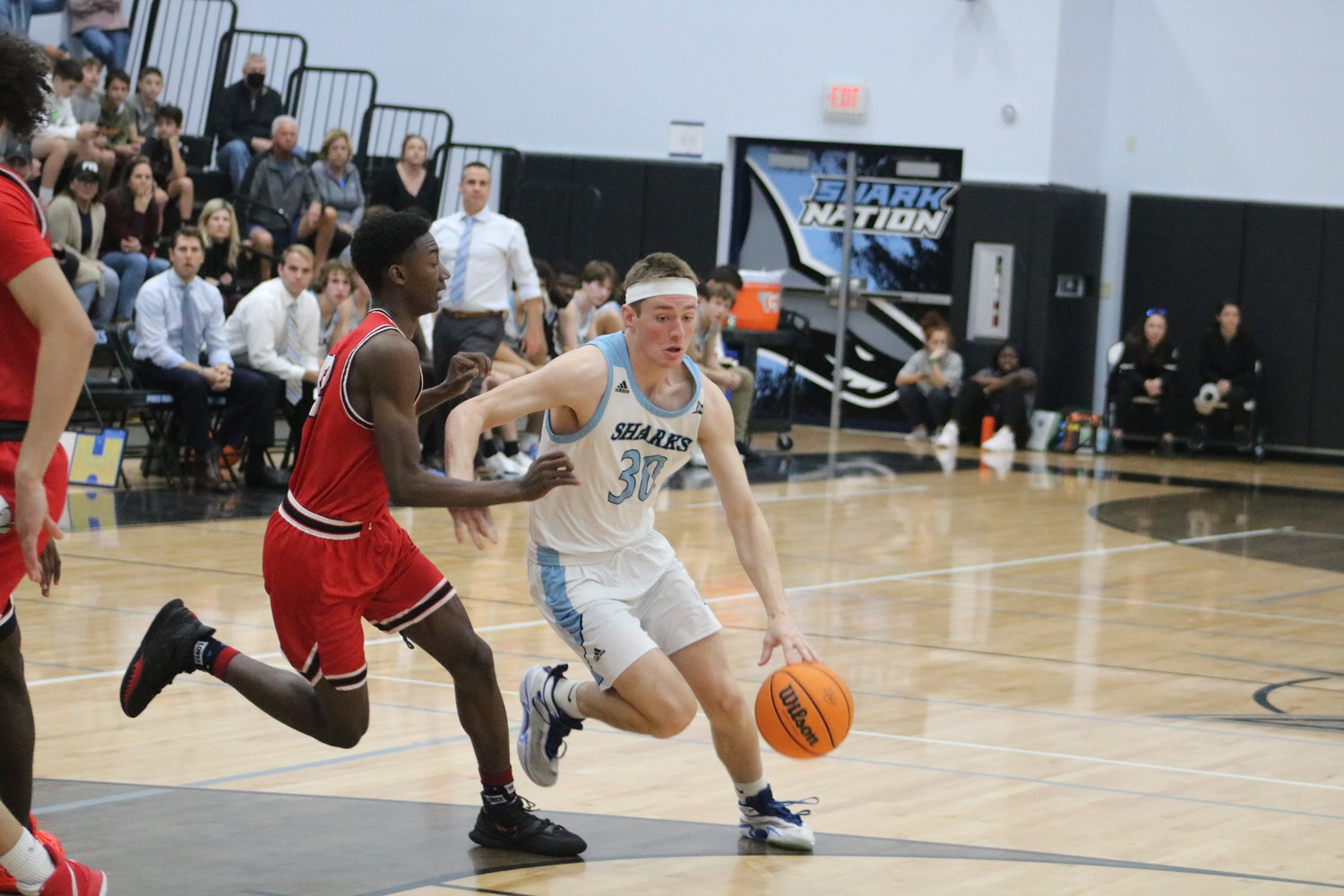 Ross Candelino drives to the basket during the regional semifinals Feb. 22. He led the Sharks with 19 points.